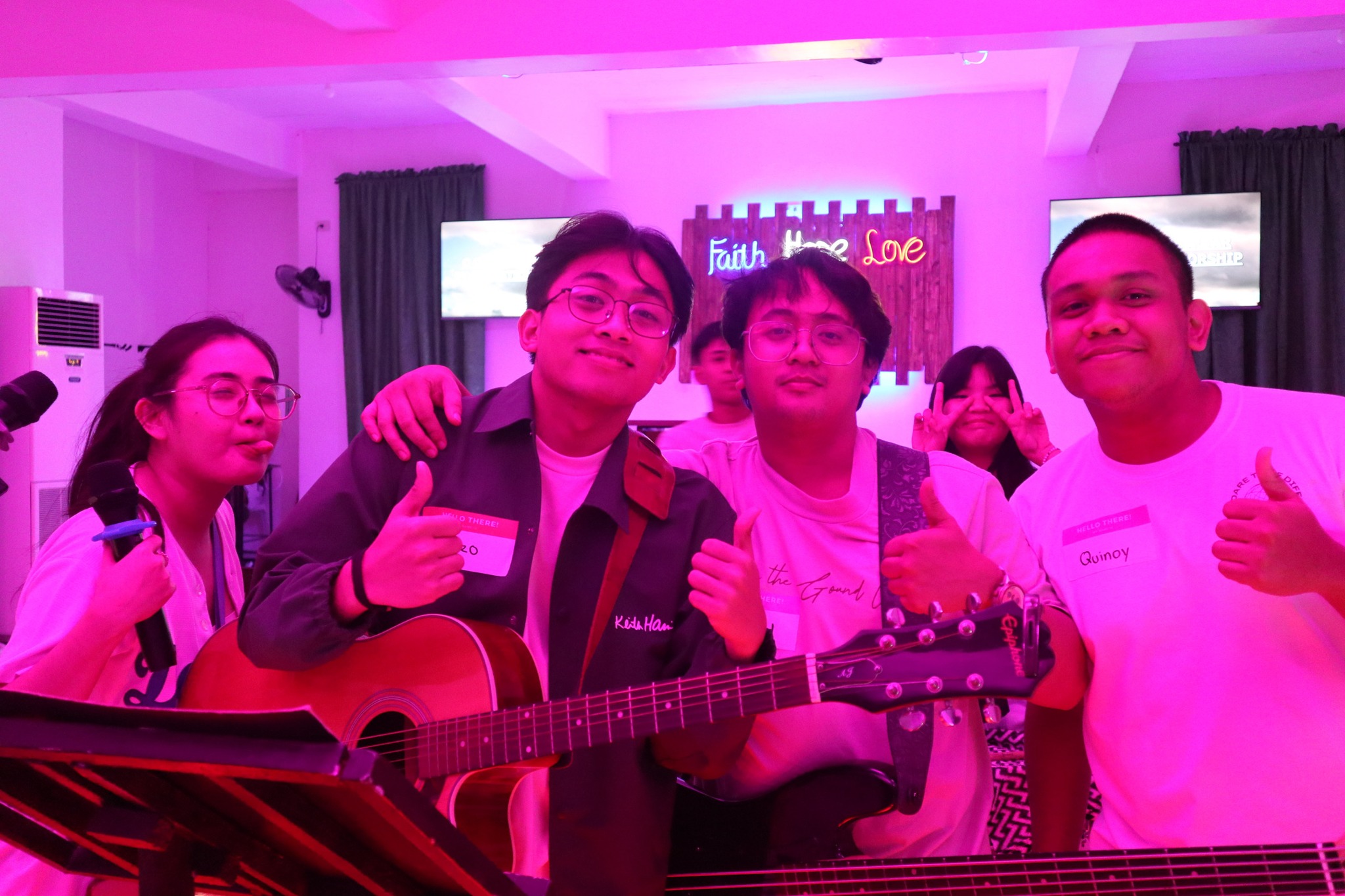 Friends posing together with their guitars at Ignite 2025